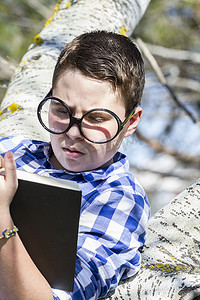 Think.Huge glasses.Student boy 在树林里看书