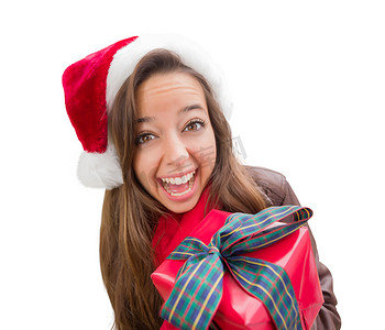 女孩戴着圣诞圣诞帽，蝴蝶结包裹的礼物被白色隔离。