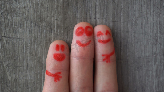 Happy fingers.beautiful faces painted on the toes