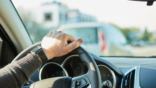 一个男人在开车时手握方向盘的特写镜头