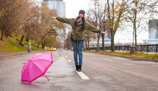 秋雨摄影照片_秋雨天带伞走路的年轻女子