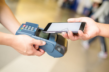 妇女通过 NFC 技术在 pos 机上付款
