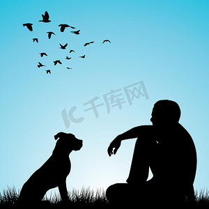 男人和他的狗坐在草地上