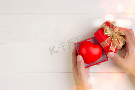 情人节，手开红色礼盒，心形木制白色背景，庆祝和周年纪​​念，给予爱，呈现浪漫和惊喜，节日和节日概念。