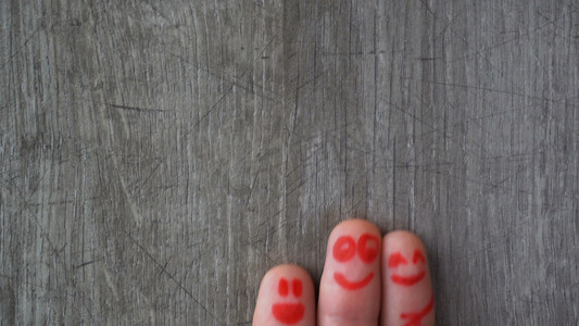 Happy fingers.beautiful faces painted on the toes