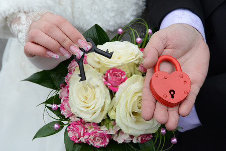 手势锁摄影照片_拿着结婚锁的情侣手