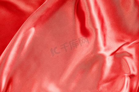 红色褶皱摄影照片_抽象背景豪华布料或液体波浪或波浪褶皱