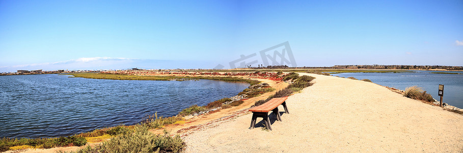 祥和摄影照片_俯瞰 Bolsa Chica 宁静祥和的沼泽的长凳