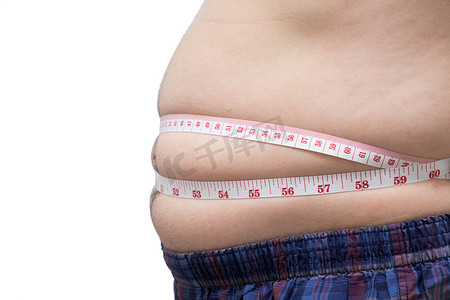 体重减轻摄影照片_肥胖的亚洲男人用腰围测量他的肚子