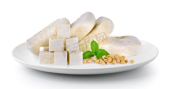 木莲豆腐摄影照片_白色背景中分离的盘子中的豆腐大豆和薄荷