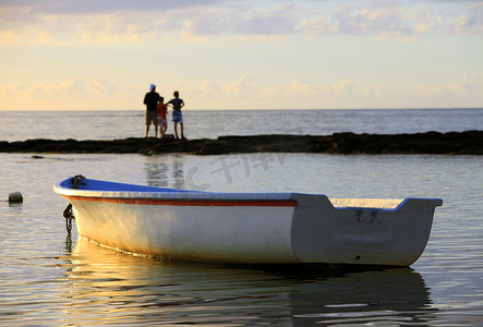 日落时靠近海滩的船