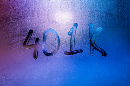401k这个词——雇主赞助的固定供款养老金账户计划——手写在夜间有雾的窗户玻璃上