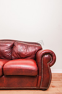 皮沙发摄影照片_空白墙前的豪华红色皮沙发