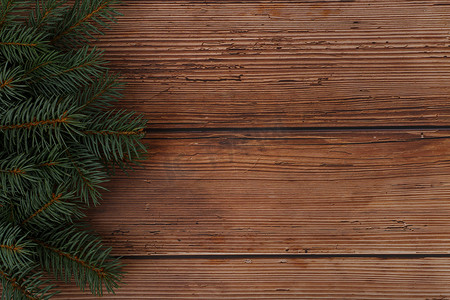 棕色木桌的顶部视图，左侧有圣诞树和文本空间