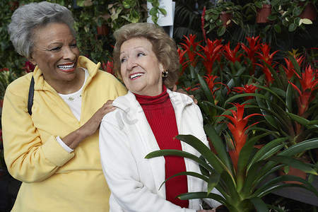 资深女性摄影照片_植物园的两个愉快的多种族资深女性朋友