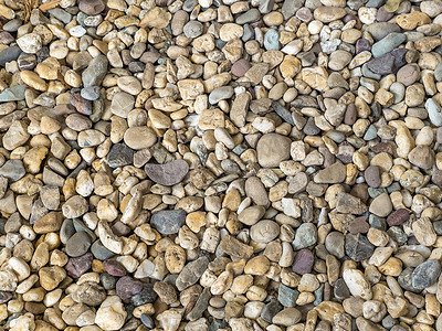石材摄影照片_花园中棕色鹅卵石石路地板自然和抽象背景