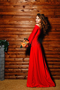 漂亮的大锅摄影照片_拿着花的红色礼服的女孩