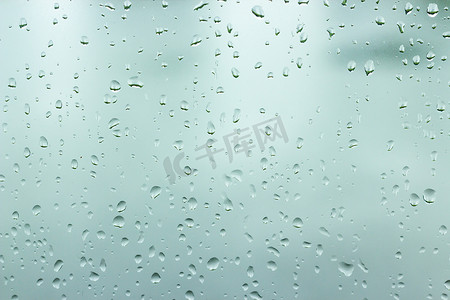 下雨玻璃窗摄影照片_玻璃窗背景上的水滴。