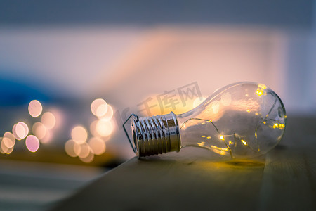 想法和创新：带 LED 的灯泡躺在一张木桌上。