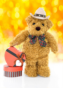 心形礼盒摄影照片_带红色心形礼盒的泰迪熊