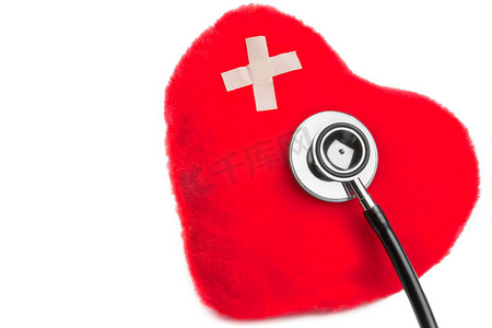 听诊器附近有贴片的可爱玩具的心脏