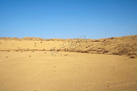开垦土地摄影照片_沙漠中的山丘。