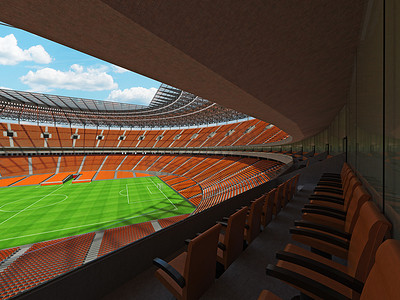 垂直俯拍足球场摄影照片_有橙色位子和贵宾包厢的大美丽的现代足球场