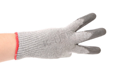 拳头指向摄影照片_戴手套的手显示三个。