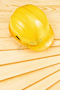 松木板上的黄色安全帽