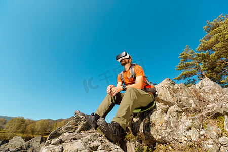 成功的年轻人，使用虚拟现实护目镜在山区旅游，在夏天度假