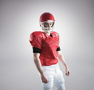 合成运动背景摄影照片_戴着头盔的美式足球运动员肖像的合成图像