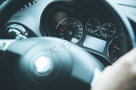 燃油摄影照片_带转速表和燃油指示器的跑车仪表板和方向盘