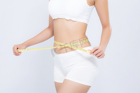 测量体重摄影照片_亚洲女性饮食和苗条，测量腰围以测量体重孤立