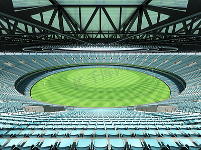 垂直俯拍足球场摄影照片_美丽的现代圆形澳式足球场，设有天蓝色座椅和贵宾包厢
