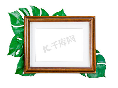 空白木制相框与绿叶隔离在白色黑色