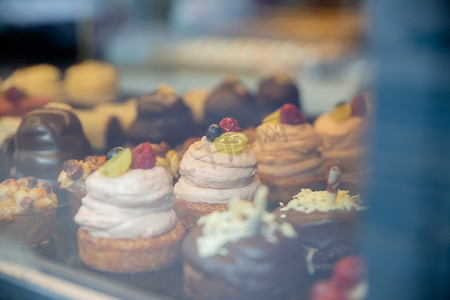 面包店橱窗里的巧克力奶油松饼和纸杯蛋糕