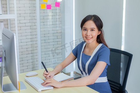 服装交易摄影照片_亚洲女商人在做重要交易时笑容灿烂