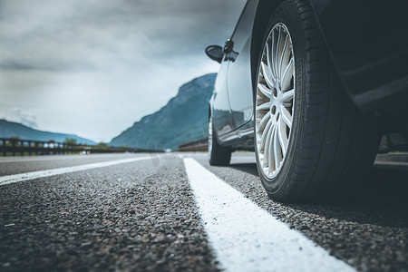 道路故障摄影照片_汽车站在故障车道、沥青和轮胎上，意大利