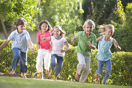 朋友跑步摄影照片_五个年轻朋友在户外跑步微笑