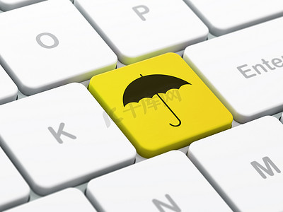 黑色的雨伞摄影照片_安全理念：电脑键盘背景上的雨伞