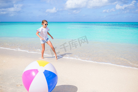 可爱的小女孩在沙滩上玩球，孩子们在户外进行夏季运动