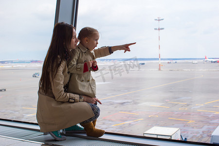 航空母摄影照片_母亲和小女儿在机场航站楼望着窗外