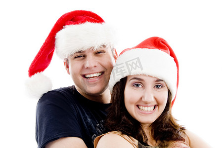 圣诞帽服装摄影照片_戴着圣诞帽的快乐夫妇的肖像