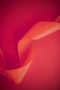 在玫瑰色背景的抽象卷曲丝带，专属豪华