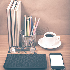 叠杯子摄影照片_办公桌：带电话的咖啡，一叠书，眼镜，钱包，