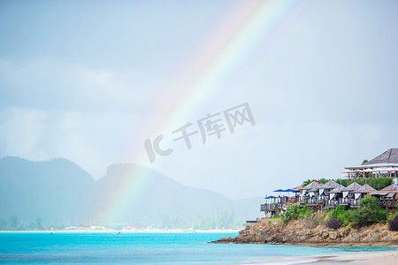 热带海滩，海洋中碧绿的海水、白色的沙滩和五颜六色的彩虹