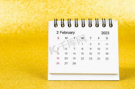 英语活动背景摄影照片_2023 年 2 月的 2023 年金色背景月度台历。