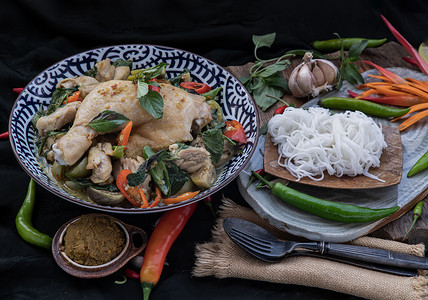 陶瓷碗中的绿咖喱鸡肉和泰国茄子 (Kaeng khiao wan) 配米粉。