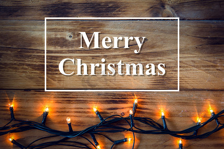 圣诞背景 — 带有灯光和文字的复古木板