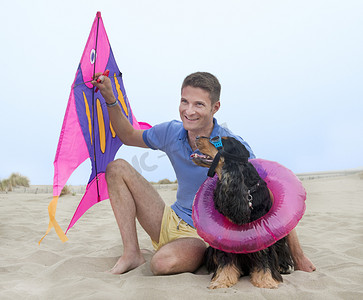 风筝玩具摄影照片_人、风筝和狗